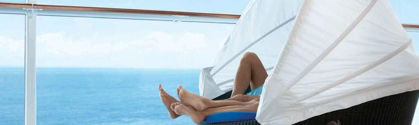 Couple lying in a bubble chair onboard Celebrity Cruises