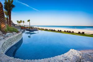 The pool overlooking the beach at JA Palm Tree Court 
